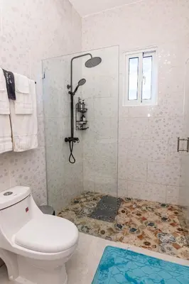 a bathroom with a shower and a toilet at Beautiful ocean and mountain view villa in Gaspar Hernández