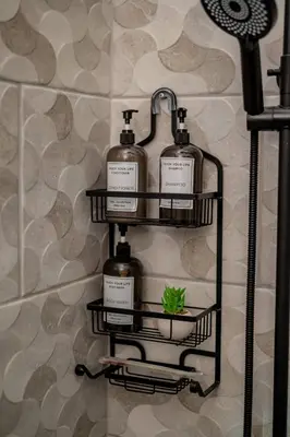 a bathroom rack with four bottles of soap and a plant at Beautiful ocean and mountain view villa in Gaspar Hernández