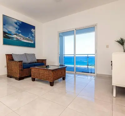 a living room with a couch and a table at Beautiful ocean and mountain view villa in Gaspar Hernández