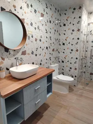 a bathroom with a sink and a mirror and a toilet at Colonial City Stay with Local Soul in Santo Domingo