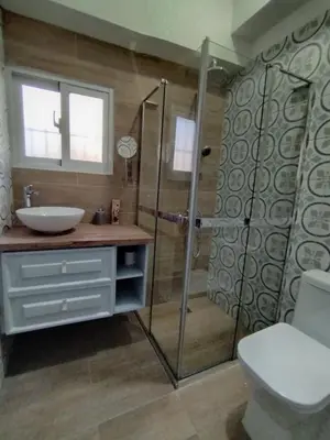 a bathroom with a shower and a sink and a toilet at Colonial City Stay with Local Soul in Santo Domingo