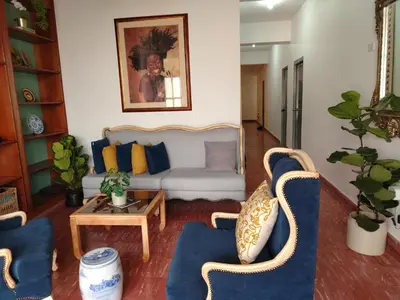a living room with a couch and chairs and a table at Colonial City Stay with Local Soul in Santo Domingo