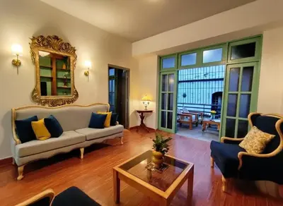 a living room with a couch and a table at Colonial City Stay with Local Soul in Santo Domingo