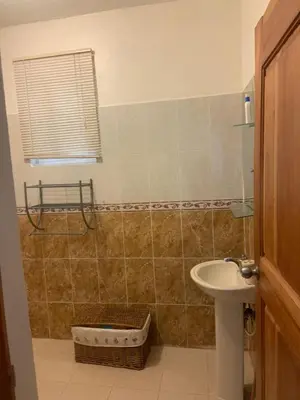a bathroom with a sink and a toilet and a mirror at Villa francia in Santa Cruz de Barahona