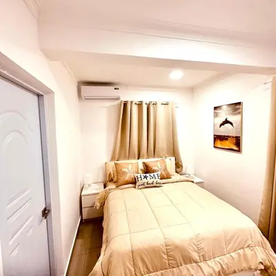 a small bedroom with a bed in a room at Central in Punta Cana Beach Life RD in Punta Cana