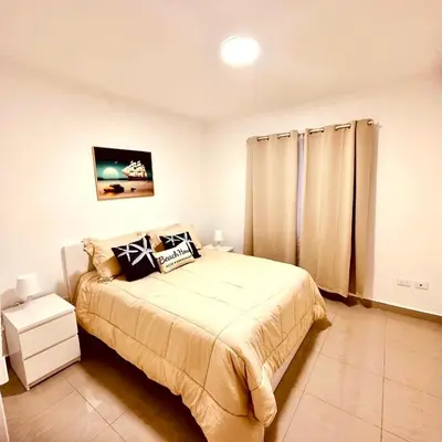 a bedroom with a large bed and a window at Central in Punta Cana Beach Life RD in Punta Cana