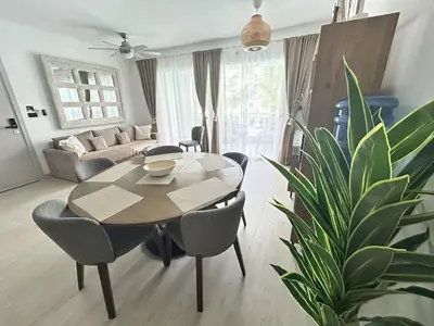 a living room with a table and chairs and a couch at Caribbean Dream Condo AC WIFI in La Laguna