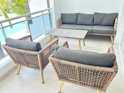 a living room with a couch and chairs and a table at Caribbean Dream Condo AC WIFI in La Laguna