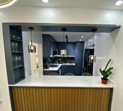 a kitchen with blue cabinets and a white counter top at Apartamento in Mendoza