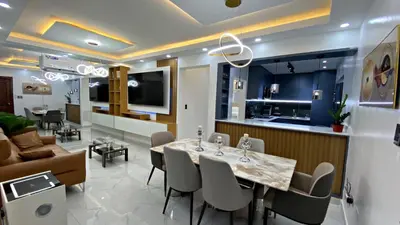 a dining room and living room with a table and chairs at Apartamento in Mendoza