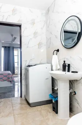 a white bathroom with a sink and a mirror at Villas Hillside apt 1 in Santa Bárbara de Samaná