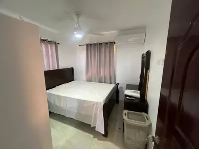 a small bedroom with a bed and a window at Villas Hillside apt 1 in Santa Bárbara de Samaná