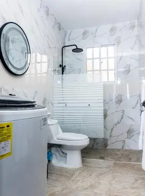 a white bathroom with a toilet and a mirror at Villas Hillside apt 1 in Santa Bárbara de Samaná
