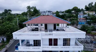 an aerial view of a white house with a red roof at Villas Hillside apt 2 in Santa Bárbara de Samaná