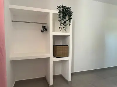 a white shelf with a potted plant in a room at Casa Entre Playas - 14 pax, 3 min de la playa en Las Galeras in Las Galeras