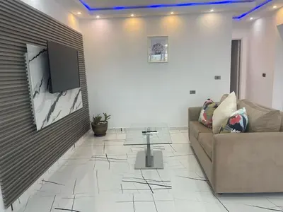 a living room with a couch and a tv on a wall at Casa Entre Playas - 14 pax, 3 min de la playa en Las Galeras in Las Galeras