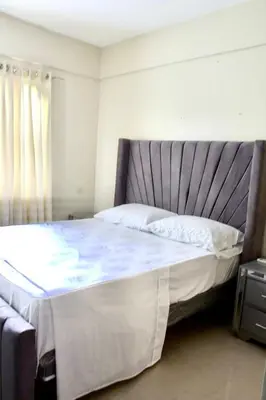 a bedroom with a large bed with white sheets at Casa de la presa in Monción