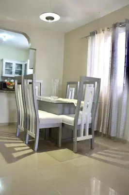 a dining room with a table and four chairs at Casa de la presa in Monción