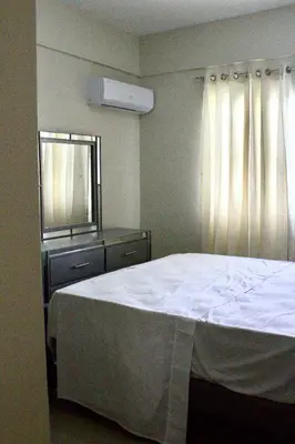 a bedroom with a bed and a dresser and a window at Casa de la presa in Monción