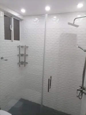 a shower with a glass door in a bathroom at Quiet apartment, good access to Supermarkets, Center etc in Santo Domingo
