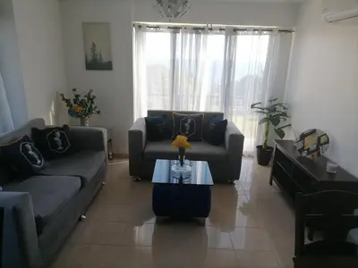 a living room with two couches and a table at Quiet apartment, good access to Supermarkets, Center etc in Santo Domingo