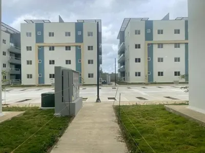 an empty parking lot with two large buildings at Your Terrazas Del Este Getaway In La Romana in Cumayasa Kilómetros Diez