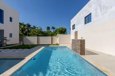 a swimming pool in the backyard of a house at Luxurious Home with Pool! in San Felipe de Puerto Plata