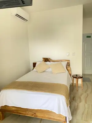 a bedroom with a large bed with white sheets at Apartamento con Vista al Mar PalmeritaVillage in El Valle