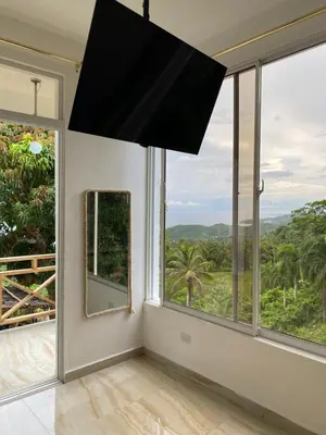 a room with large windows and a large chandelier at Apartamento con Vista al Mar PalmeritaVillage in El Valle