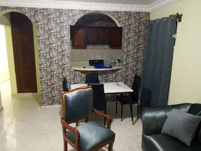a living room with a table and chairs at confor y seguridad in Santo Domingo