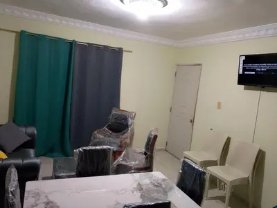 a living room with chairs and a green curtain at confor y seguridad in Santo Domingo
