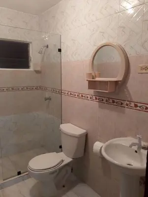 a bathroom with a toilet and a sink and a shower at confor y seguridad in Santo Domingo