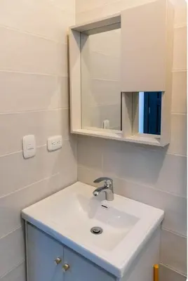 a bathroom with a white sink and a mirror at Esmeralda modern apartment at Romana del Oeste in La Romana