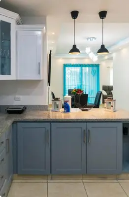 a kitchen with blue cabinets and a counter top at Esmeralda modern apartment at Romana del Oeste in La Romana
