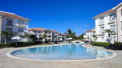 a swimming pool in front of some buildings at Lovely apartment by the Caribbean in Bayahibe