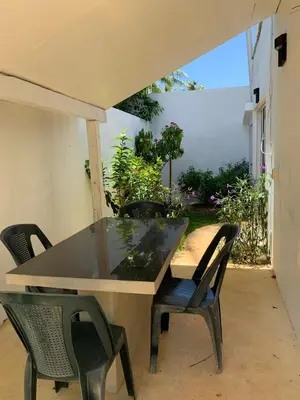 a glass table and chairs on a patio at Beach Hotel Casa Nina in Las Terrenas