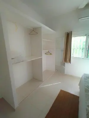a white bathroom with shelves and a window at Beach Hotel Casa Nina in Las Terrenas