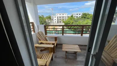 a balcony with two chairs and a table and a window at Residencial Paraiso in Bayahibe
