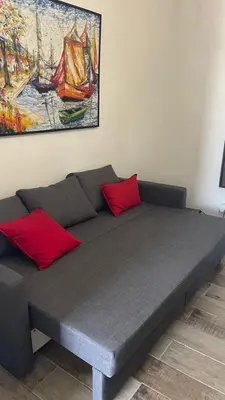 a bed with two red pillows in a room at Residencial Paraiso in Bayahibe