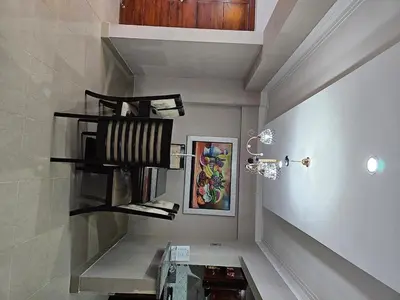 a room with a staircase with shelves and a painting at Oasis Colonial in Santo Domingo