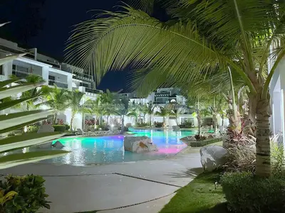 a swimming pool at a resort at night at Estrella Dominicus Apartamento - Bayahibe in Bayahibe