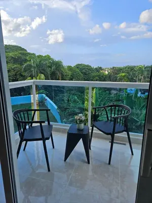 a balcony with two chairs and a water slide at Full Department 2 hab in Las Terrenas