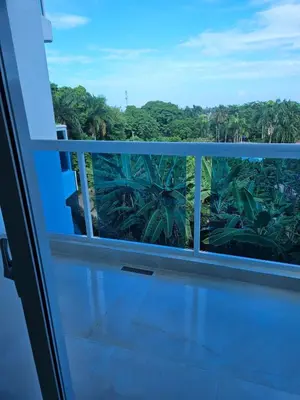 a balcony with a view of a jungle at Full Department 2 in Las Terrenas