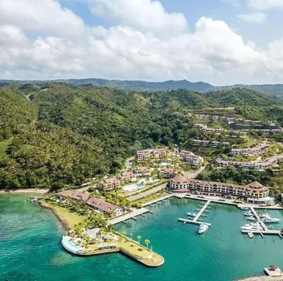 an aerial view of a resort with boats in the water at Penthouse Suite at Puerto Bahia in Samana in Los Grini