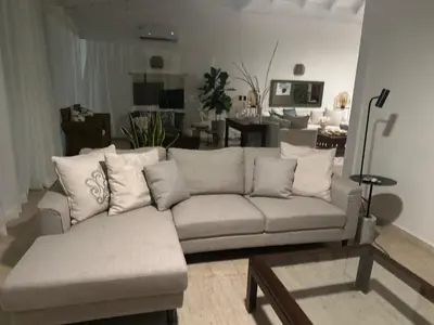 a living room with a couch and a table at Villa Paz in La Romana