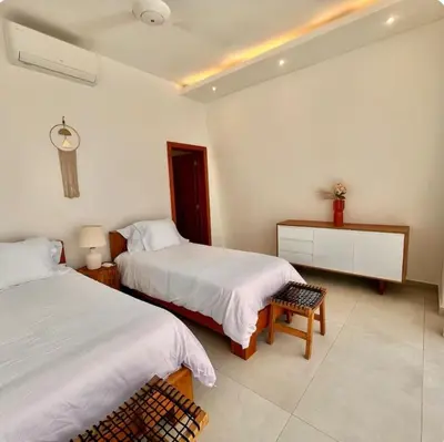 a bedroom with two beds and a dresser in it at 5 Bedroom Villa With Daily Housekeeping in Las Terrenas