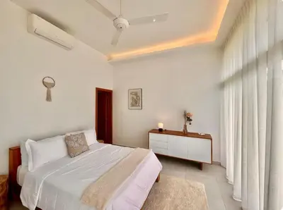 a bedroom with a bed and a dresser and a window at 5 Bedroom Villa With Daily Housekeeping in Las Terrenas