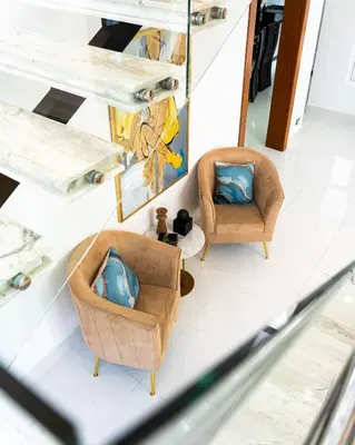 two chairs in a living room with blue pillows at Modern and luxurious house in Santiago in Santiago de los Caballeros