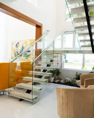 a glass staircase in a living room with a couch at Modern and luxurious house in Santiago in Santiago de los Caballeros