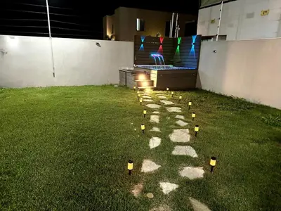 a row of small lights on the grass at Modern and luxurious house in Santiago in Santiago de los Caballeros